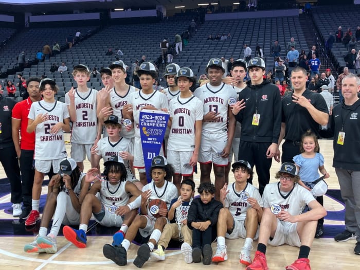 Modesto Christian celebrates then poses after 68-63 win over Lincoln for the Sac-Joaquin Section D1 championship at Golden 1 Center.